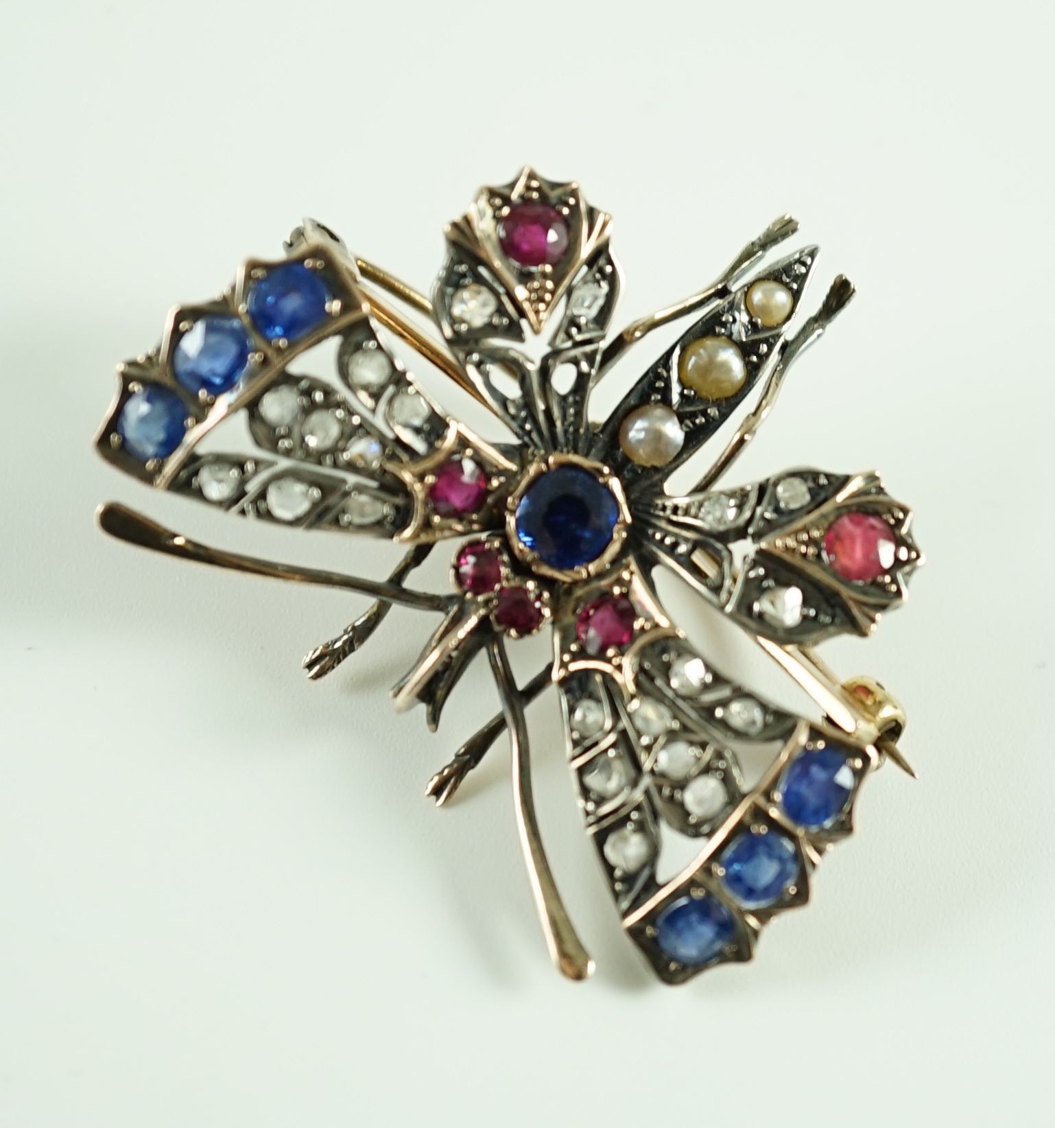 A Victorian gold and silver, diamond, ruby, sapphire and split pearl set butterfly brooch